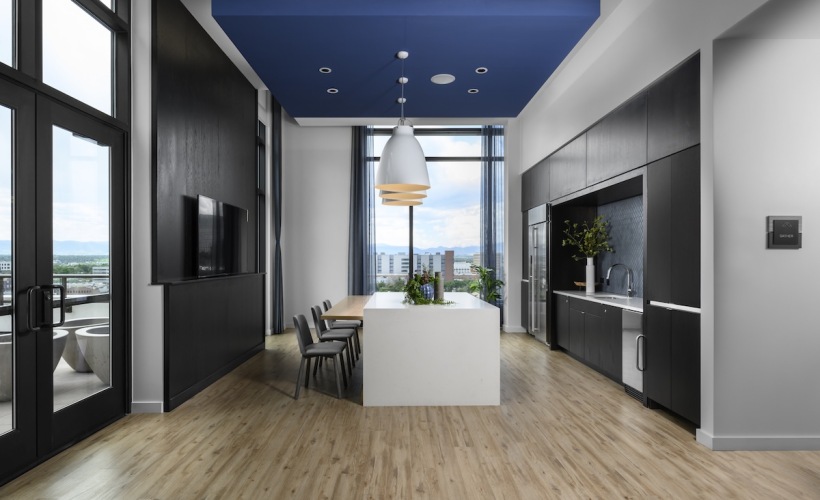 a room with a kitchen and an island