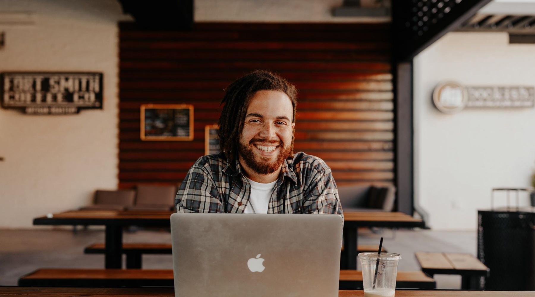 guy smiling while working on laptop