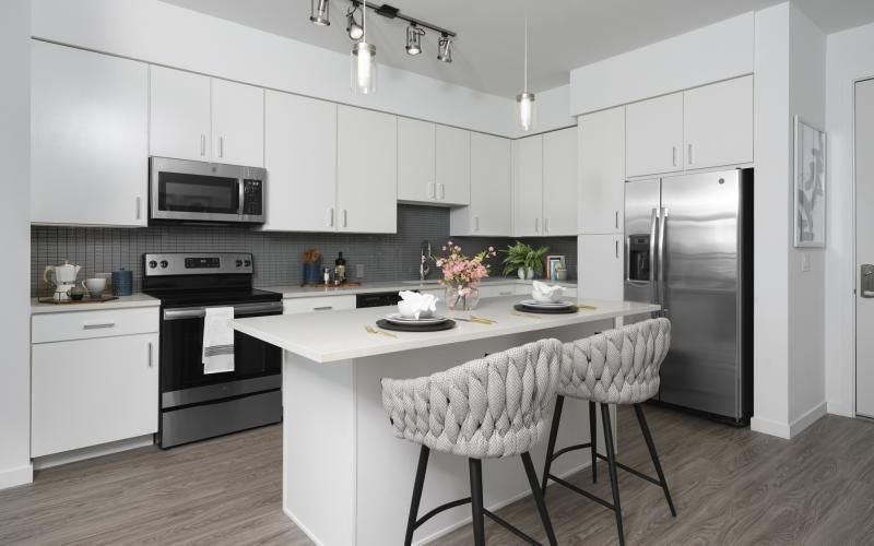 a kitchen with white cabinets